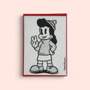 Artwork featuring a black and white cartoon illustration of a girl with a beanie, bordered by a red frame, displayed against a solid pale pink background.