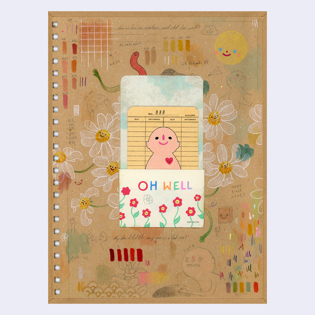 Drawing on the back of a hardcover sketchbook cover with a library card attached, with a tan colored character with a heart.