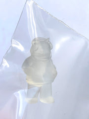 Mini clear figure of a bear wearing a hoodie and pair of headphones, its hands are in its pocket.