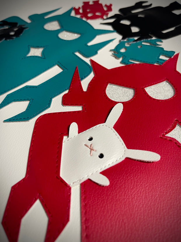Detail shot of vinyl fabric record cover, featuring cut outs of blue, red and black Big Boss Robots. One holds a small white bunny under its arm.