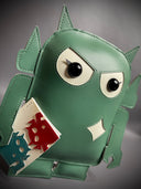 Sage green vinyl fabric plush of a Big Boss Robot, slightly shorter and with large eyes. It holds a small white magazine with a red and a blue robot on it.
