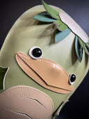  Vinyl plush sculpture of a green kappa, with leaves coming off the top of its head and a beak. It has fins for hands.