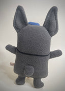 Flat plush doll of a gray French Bull dog with pointy ears, standing on 2 legs like a person. It has black bead eyes and wears a navy bowtie and matching beret cap.