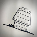 A vinyl fabric artwork depicting a cartoon rabbit laying flat on its back atop a dog house, crafted from off-white leather with black stitched outlines and details, displayed on a textured off-white background.