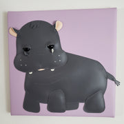 Vinyl fabric sculpture of a cartoon style baby hippo on a lilac colored square canvas.