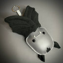 Vinyl fabric plush keychain of a bat, upside down with a keyring attachment.