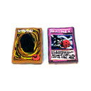 Two hand-painted clay cards on a white background. The left card is brown with yellow swirls, a black center.