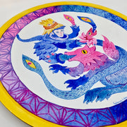 Bright blue and pink illustration on a circular panel with a yellow outline. A wolf creature is opens its mouth, a large blue snake creature comes out with a person's face.