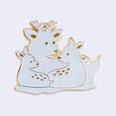 A white enamel lapel pin featuring a family of 3 deer, including a stag and two fawns, outlined in gold metal with small gold spots on a light gray background.