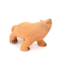 Ceramic figurine of a stylistic jaguar with yellow eyes.