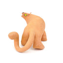 Ceramic figurine of a stylistic jaguar with yellow eyes.