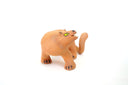 Ceramic figurine of a stylistic jaguar with yellow eyes.