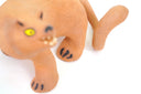 Ceramic figurine of a stylistic jaguar with yellow eyes.