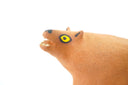 Ceramic figurine of a stylistic jaguar with yellow eyes.