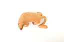 Ceramic figurine of a stylistic jaguar with yellow eyes.