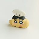 A hand-painted clay figurine of Crayon Shin-Chan's head, with black hair and a small white dog on its head, set against a plain light gray background.