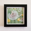 Watercolor illustration of a dandelion, with its wisps flying away. Atop of it sits a white simplistic character.