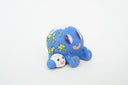 Ceramic sculpture of a blue planet with green floral dots, smiling and sitting next to a tiny moon.