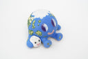Ceramic sculpture of a blue planet with green floral dots, smiling and sitting next to a tiny moon.