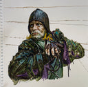 Illustration of a man in a metal helmet and metal armour, looking off to the side.