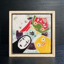 Ceramic tile of a light blue background with a dark purple circle. 4 characters surround each side: No Face, a large duck, a masked character and a radish spirit.