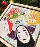 Ceramic tile of a light blue background with a dark purple circle. 4 characters surround each side: No Face, a large duck, a masked character and a radish spirit.