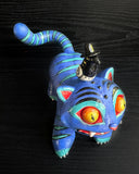Colorful figurine of a blue cat with a small bird figure on its back against a black background