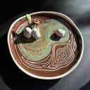 Ceramic dish with decorative elements on a dark surface