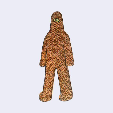 Die cut wooden sculpture of a cyclops monster with a lanky body, all covered with orange leaves.