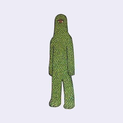 Die cut wooden sculpture of a cyclops monster with a lanky body, all covered with green leaves.