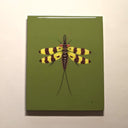 A resin coated artwork featuring a detailed illustration of a yellow and black striped insect on an olive green background, displayed against a plain off-white wall.