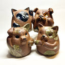 Group of 4 brown ceramic animals, rounded with cute front paws and a rounded bottom without legs.
