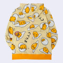 Light yellow hooded jacket with a repeating all over pattern of Gudetama, sitting on egg yolk, inside of an egg shell or wrapped in bacon. 