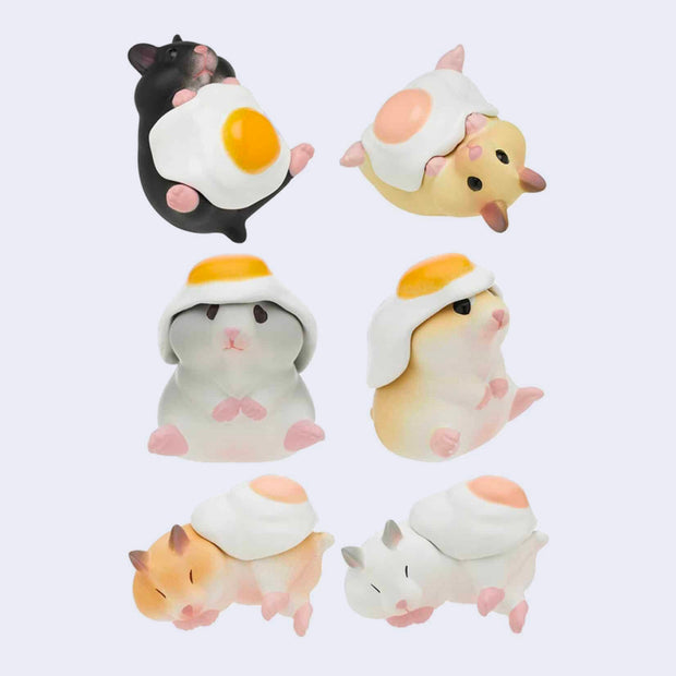 6 small plastic hamsters, different colors all with a sunny side egg sitting on their body, either atop their head, on their stomach or on their sides.