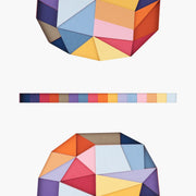 Geometric designed layered cut paper sculpture, creating a three dimensionality. Along the top and bottom are multi sided shapes with many triangles and polygons within them. In the center of the piece is a strip of squares, showing each color used in a gradient.