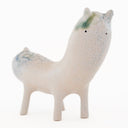 Ceramic sculpture of a long bodied, skinny character with small ears and eyes standing on 4 short legs.