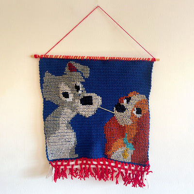 Crochet of the 2 dogs from Lady and the Tramp sharing a piece of spaghetti.