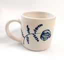 White mug with blue floral design on a white background