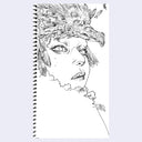 Spiral-bound notebook with a black and white illustration of a woman's face with a dragon on her head.