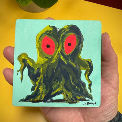 Painting of Hedorah, a dark green smog slime monster with large red eyes. It stands with its arms slightly extended. Background is mint blue.