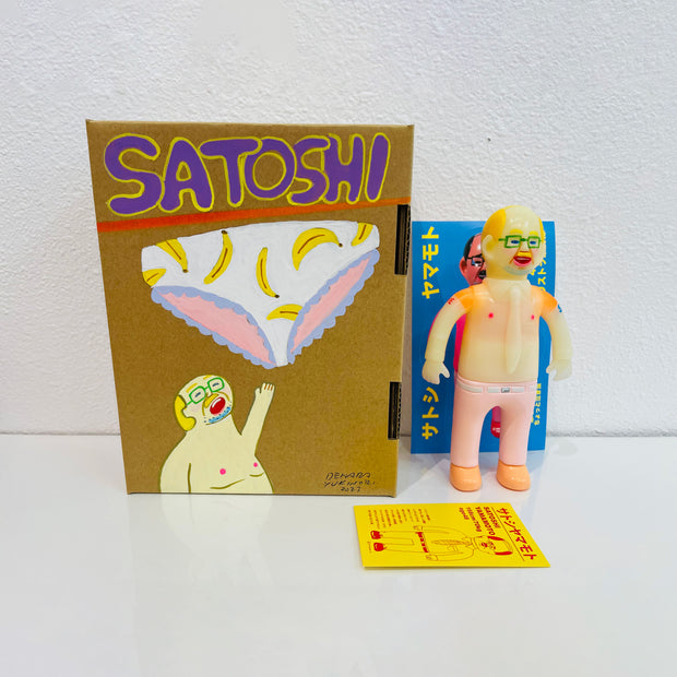 Semi translucent soft vinyl figure of a business man, shirtless in light pink slacks. He stands next to a painted box. 