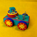 Colorful wooden toy car with a robot figure on a yellow background