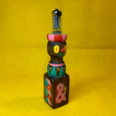 Decorative wooden stand with a cute cartoon face and retro style painting with a light bulb on a yellow background