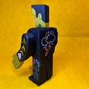 Assembled wooden sculpture of a Frankenstein character, with moving arms and subtle floral patternings.