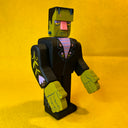 Assembled wooden sculpture of a Frankenstein character, with moving arms and subtle floral patternings.