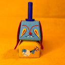 Colorful wooden toy resembling a dog with a very skinny blue top hat and a yellow body with painted on arms playing a banjo.