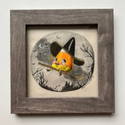 Color pencil drawing of a cartoon style candy corn, wearing a large black witch's hat and riding a broom over a night forest.