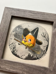 Color pencil drawing of a cartoon style candy corn, wearing a large black witch's hat and riding a broom over a night forest.
