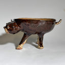 Glossy dark brown ceramic bowl with 3 dog heads jutting out, all sharing a bowl body with 4 legs. 
