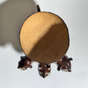 Glossy dark brown ceramic bowl with 3 dog heads jutting out, all sharing a bowl body with 4 legs. 